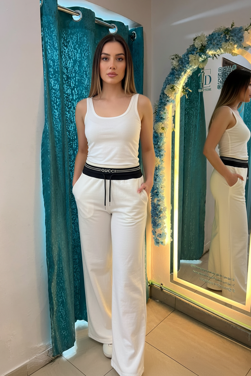 Model 1 in white Gucci sweatpants